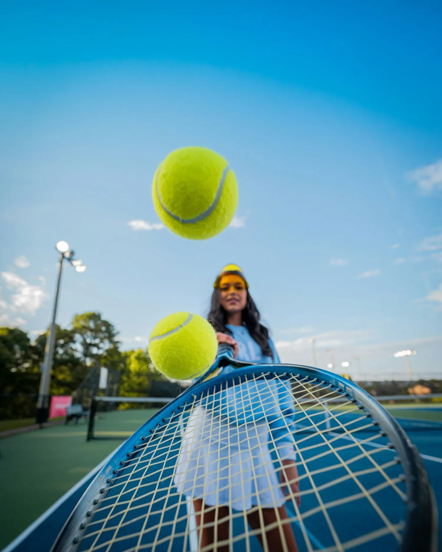 Tennis balls flying over a racket