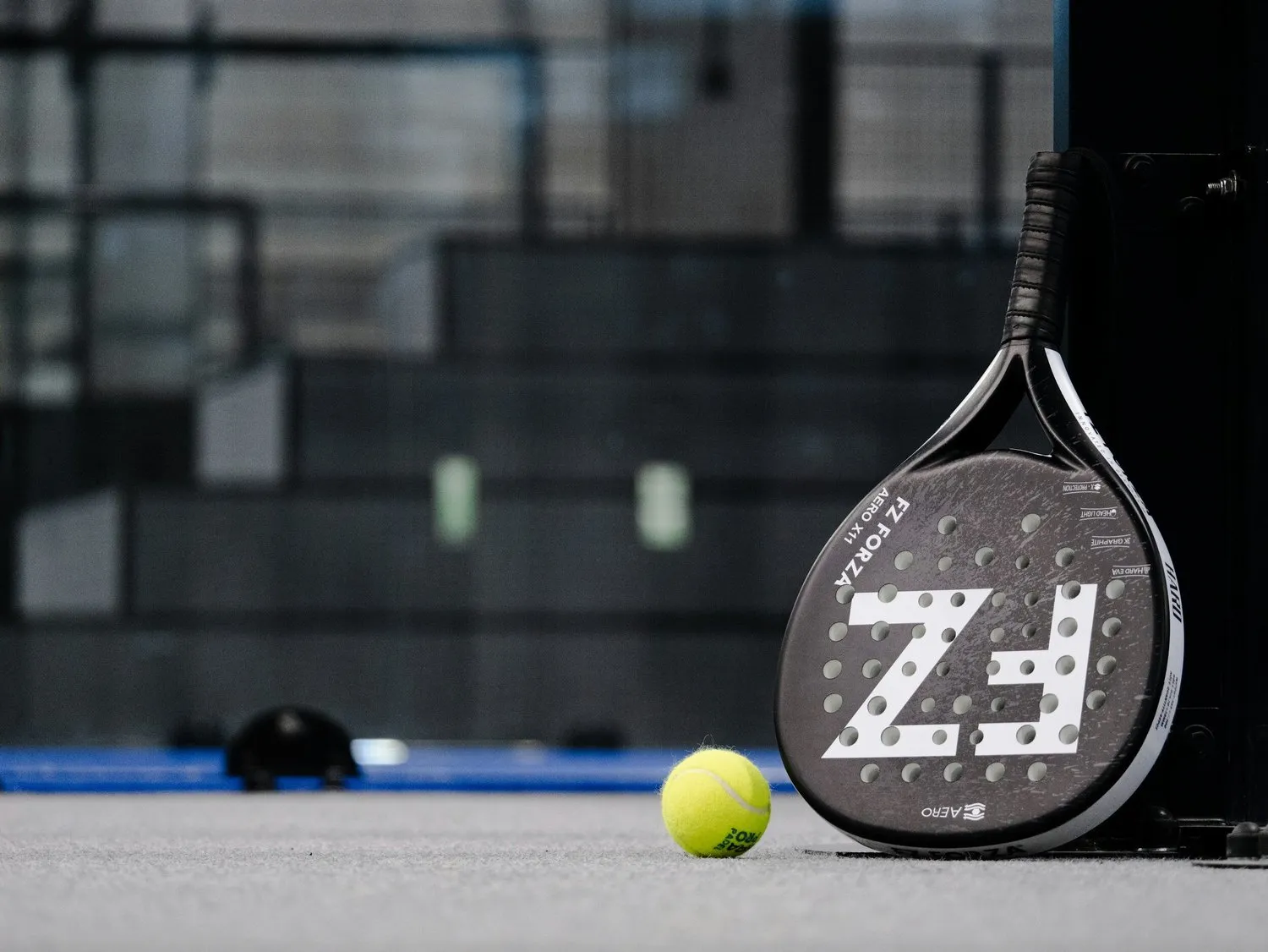 Padel racket and ball on court
